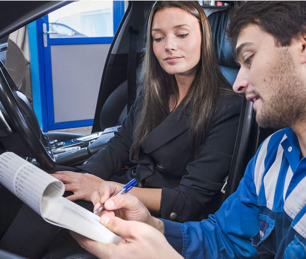 Mechanic going over prices with customer