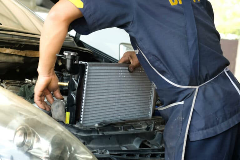 mechanic repairs car radiator