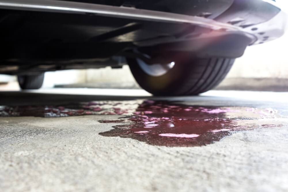 Pink Fluid Leaking from Car indicates Coolant Leak